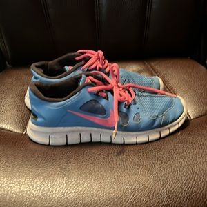 Blue and pink Nike free runs